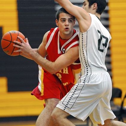 North Catholic's Danny Savulchak, left, looks to pass around Mercyhurst's Curtis Jones in the first half Friday at North Allegheny. North Catholic won, 53-30.