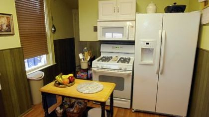 The 12-by-11-foot kitchen has new Pergo flooring, countertops and backsplash.