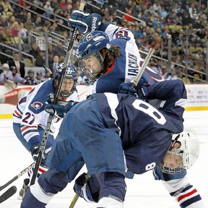 Robert Morris' Scott Jacklin battles for a loose puck with Penn State's Michael McDonagh in the first period Friday at Consol Energy Center.