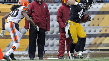 The Steelers' Troy Polamalu pulls in his 30th career interception against the Browns' Travis Benjamin in the first quarter.