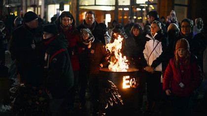 A crowd gathers to watch Steel Town Fire, a fire performance troupe, perform their routine at Pittsburgh's First Night New Years Eve festivities on Monday night.