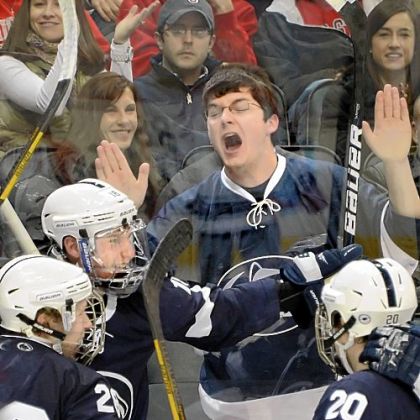 A Penn State fan celebrates as players from the Nittany Lions mob Casey Bailey (second from left) after he scored a goal in the second period against Ohio State at the Three Rivers Hockey Classic at Consol Energy Center. Total attendance for the two-day Classic was 22,460.