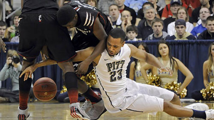 Pitt's Trey Zeigler gets called for a foul as he reaches for a loose ball against Cincinnati's Shaquille Thomas in the first half at the Petersen Events Center.