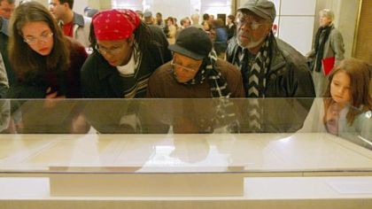 Visitors view the original Emancipation Proclamation during a one-day-only exhibit Jan. 19, 2003, at the National Archives in Washington.