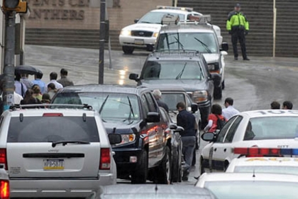 People cross DeSoto Street as they leave the scene at the shootings this afternoon at Western Psychiatric Institute and Clinic in Oakland.