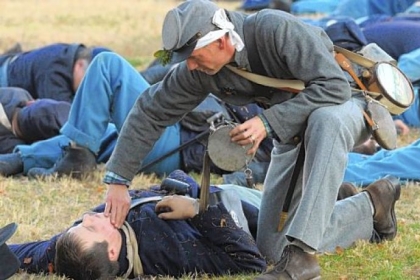 Kevin Shroyer of Goode, Va., tends to a Union soldier on Trench Hill during the 150th anniversary re-enactment of the Battle of Fredericksburg. He was one of four Confederate re-enactors chosen to portray Sgt. Richard Kirkland, known as the Angel of Marye's Heights.